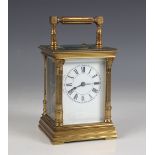 An early 20th century French lacquered brass repeating carriage clock, the case with fluted