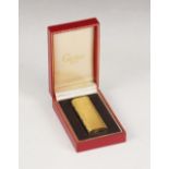 A Cartier gold plated lighter, the body with brush textured finish, numbered 50535A, 7cm high,