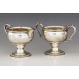 An early 20th century silver coloured milk jug and sucrier, the plain polished bowls with