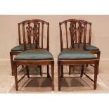A set of four walnut Hepplewhite style dining chairs, late 19th/early 20th century, the arched