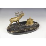 A brass and marble desk stand, late 19th/early 20th century, the oval marble base set with a brass