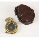 A cased WWI military brass bodied pocket compass, the base with broad arrow, serial number F-L No.