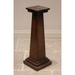 An oak pedestal jardinière stand, 20th century, the square tapering column extending to a stepped