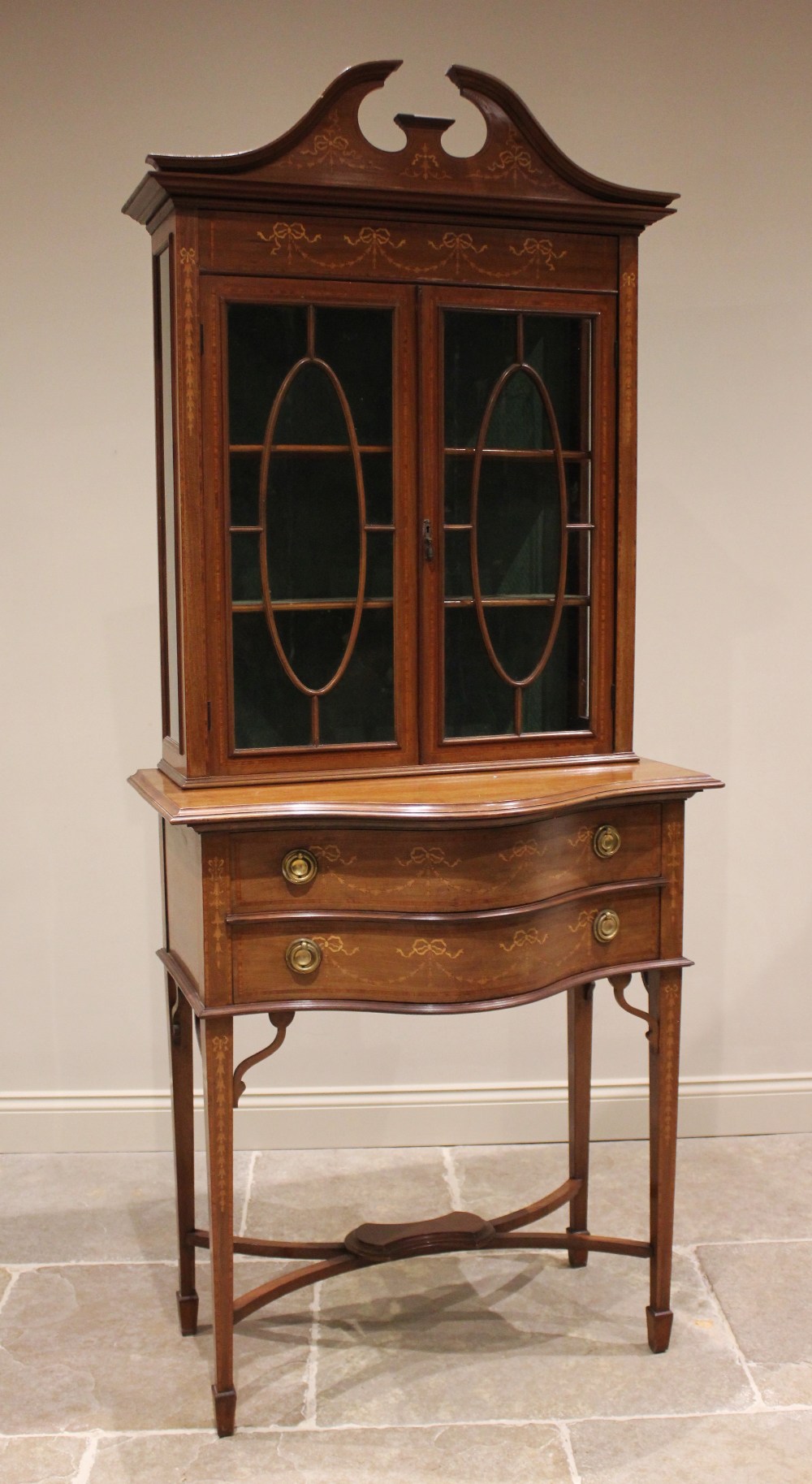 An Edwardian inlaid mahogany display cabinet on chest, in the manner of Edwards & Roberts, with a
