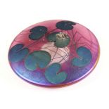 A John Ditchfield for Glasform iridescent paperweight, of squat circular form with applied cast