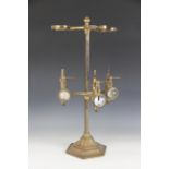 An Edwardian brass freestanding three bottle spirits dispenser, by Gaskell & Chambers, the three