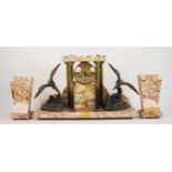 A 1930's Art Deco variegated marble portico mantel clock garniture, the suspended 10cm drum dial
