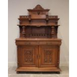 A late 19th/early 20th century French carved oak and rouge marble buffet sideboard, the