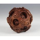 A Chinese carved wood Zodiac puzzle ball, the exterior carved with the twelve Chinese Zodiac