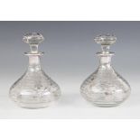 A pair of early 20th century glass scent bottles, the colourless glass bodies of baluster form, with