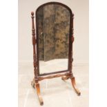 A Victorian mahogany framed cheval mirror, the rectangular arched mirror within a moulded frame,