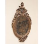An English/Northern European carved limewood baroque wall mirror, in the manner of Daniel Marot,