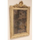 A George III gilt wood and gesso wall mirror, the speckled mirrored plate within a frame moulded