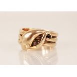 A 9ct gold snake ring, the snakes head modelled with diamond shaped eyes and coiled tail to a reeded