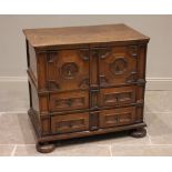 A late 17th/early 18th century two section oak chest of drawers, the upper section with a