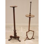 A 19th century style mahogany torchere, early 20th century, the shaped top with a moulded rim raised