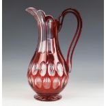 A Victorian ruby red flashed cut glass ewer, of baluster form with scalloped rim and loop handle