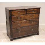 An 18th century oak chest of drawers, the moulded three plank top above two short and three long
