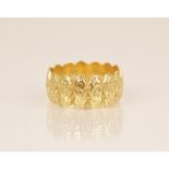 An 18ct gold dress ring, the textured band with scalloped borders, marks for MS&S London (date