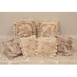 Three pairs of Aubusson style needle-point tapestry cushions, each worked with floral sprays in red,