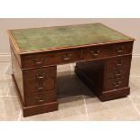 A George III mahogany twin pedestal desk, the rectangular moulded top inset with a gilt tooled green