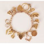 A 9ct gold charm bracelet, the curb link bracelet with 9ct gold heart-shaped padlock fastening,