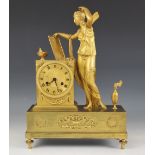 A late 19th century French gilt metal mantel clock, of podium form, the case surmounted with a