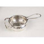 A George V silver tea strainer and stand, W J Myatt & Co, Birmingham 1933, the circular bowl with
