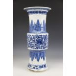 A large Chinese porcelain blue and white Gu vase, 18th/19th century, decorated with formal scrolling