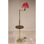 A brass freestanding adjustable reading lamp, 20th century, the articulated arm raised