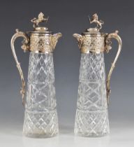 A pair of cut glass silver plated decanters, each of tapering cylindrical form with star cut