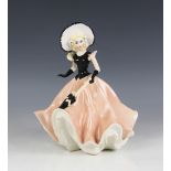 An Italian Studio figure of a lady, 20th century, modelled wearing a black bodice, hat, gloves and a