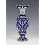 A Czechoslovakian blue overlay Bohemian vase, 20th century, the baluster shaped vase with an all
