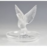 A Lalique glass trinket dish, with central frosted glass dove with open wings, engraved "Lalique