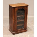 A Victorian walnut music cabinet, the rectangular top with canted front corners inlaid with a