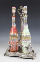 A Victorian three bottle decanter stand, late 19th century, the trefoil base raised on scroll and