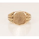 An Edwardian 9ct gold signet ring, the shield shaped head with monogrammed initials, set to reeded