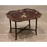 A Victorian papier mache tray top table, the shaped tray centred with a painted spray of blooms,