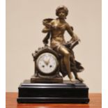 A late 19th century French spelter figural mantel clock, the case surmounted with a figure 'L'