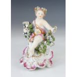 A Derby porcelain chamberstick, mid 18th century circa 1765, modelled as a seated putto upon a