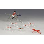 A Murano style coloured glass hunting group, comprising horse and rider, 15cm long, five hounds,