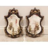 A pair of French gilt metal Rococo style mirrored girandoles, the leaf swept walnut frames