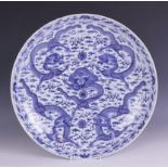 A large Chinese porcelain blue and white 'Dragon' charger, Kangxi mark, the shallow circular charger