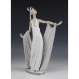 A Lladro 'Grand Dame' figure, No. 1568, modelled standing in a dress with extended arms supporting a