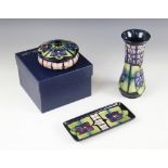 Three Moorcroft pieces decorated in the "Violet" pattern designed by Sally Tuffin, comprising a
