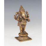 An Indian bronze figure of Ganesh, early 20th century, modelled standing on a circular base and
