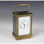 An early 20th century lacquered brass carriage clock, the 7cm white dial applied with Roman numerals