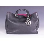 A Christian Dior Diorissimo handbag, the grained black leather with fuchsia interior and silver