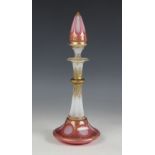 A Bohemian glass scent bottle and stopper, 19th century, of trumpet form with pink and opaline