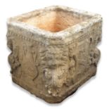 A 17th century style carved Istrian stone planter, of cubic form, with canted corners, carved with